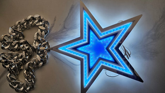 A 10 inche glowing blue star-shaped LED light with a metallic silver frame, shown next to a chunky silver chain on a light gray background.